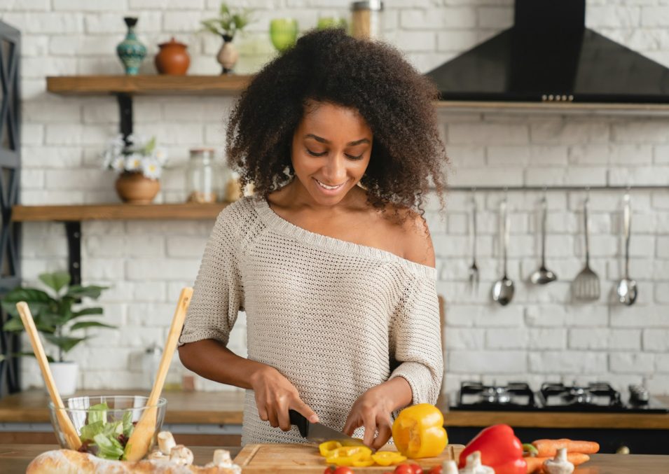 Girl cooking breakfast, making vegetable vegan salad for slimming, dieting, healthy eating habits